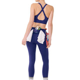 Woman wearing a blue sports bra and leggings with a white background