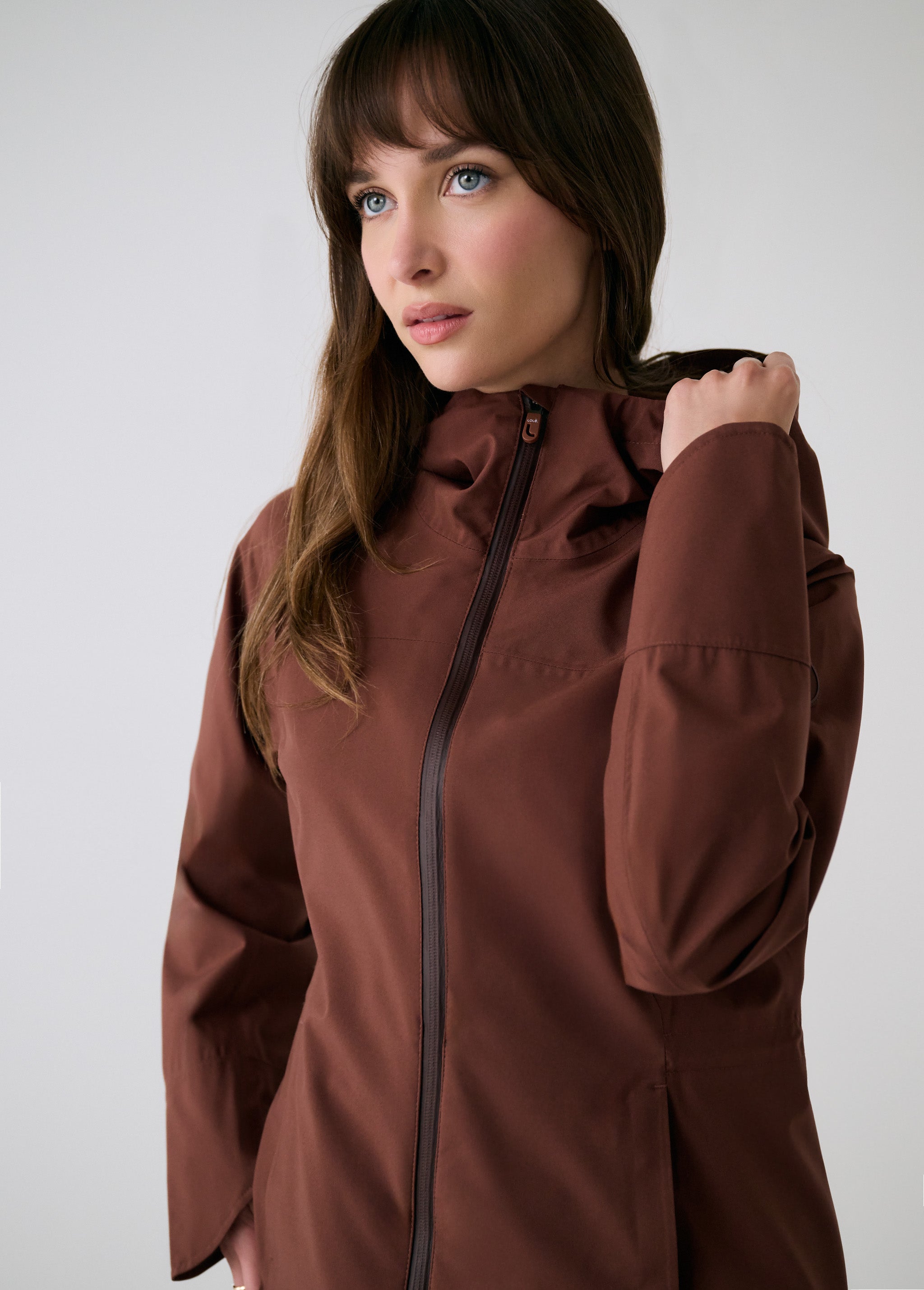 Lolë Element Long Rain Jacket in Sienna brown — this longline jacket keeps water out while keeping your look sharp